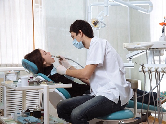 woman in dental chair having her teeth cleaned