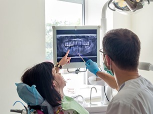 implant dentist in Arlington showing a patient their X-rays 