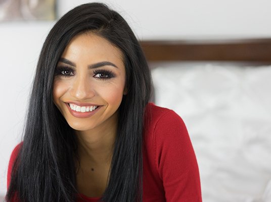 Woman with an attractive smile after cosmetic bonding.