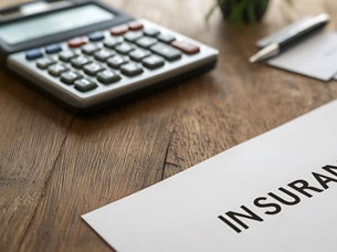 Insurance document next to calculator