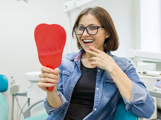 woman smiling in red mirror