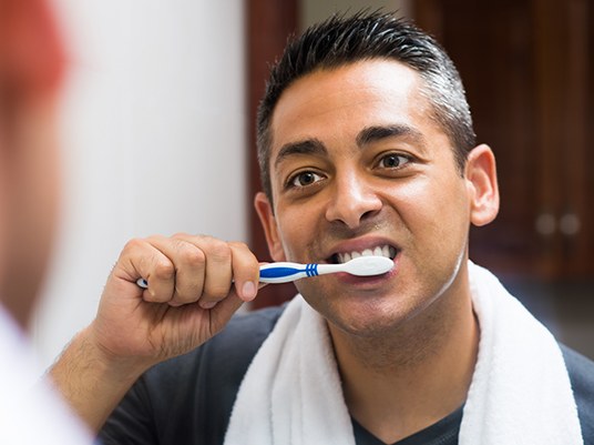 man brushing teeth