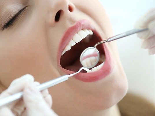 woman at dental exam with Delta Dental in-network dentist