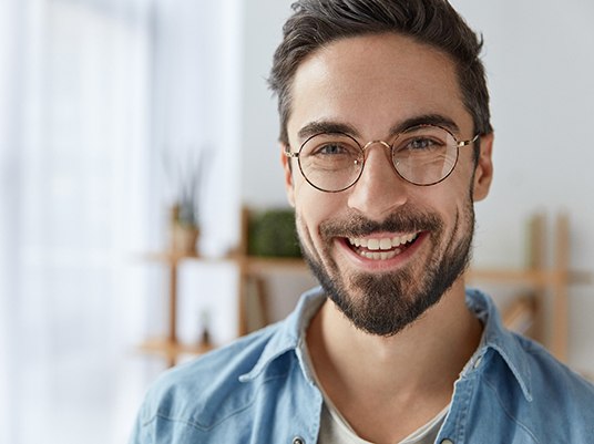 Man smiles after visiting his dentist 