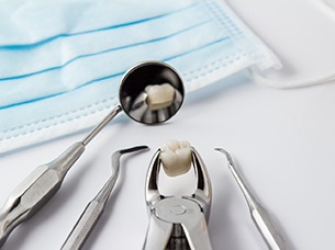 Close-up of tooth and instruments after tooth extraction in Arlington, TX