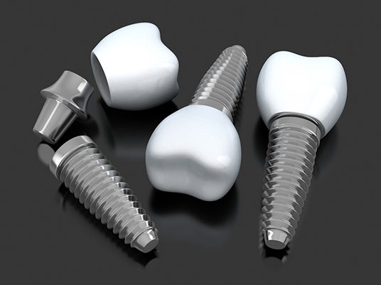 Closeup of dental implants in Arlington on dark background