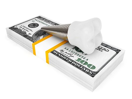 Implant on money stack representing cost of dental implants in Arlington 