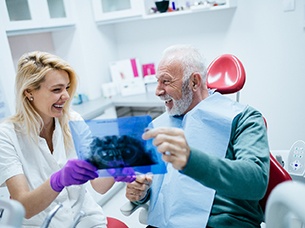 Man admiring his new dental implants in Arlington 