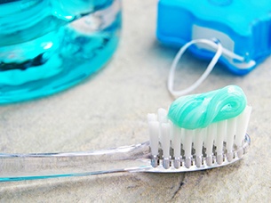 Closeup of Toothbrush and toothpaste that clean dental implants in Arlington 