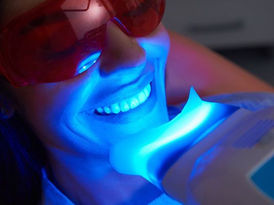 woman receiving in-office teeth whitening 