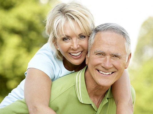 man giving wife piggyback