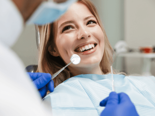 blonde girl smiling up at dentist