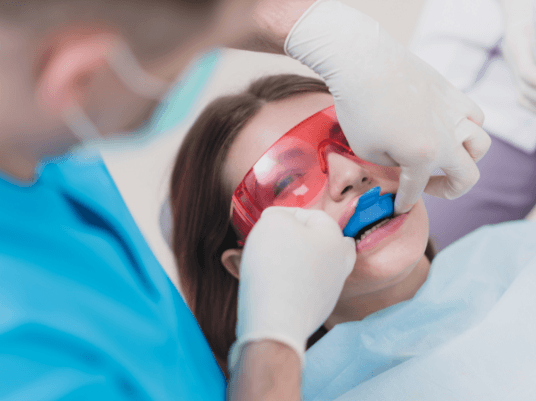 girl getting fluoride treatment