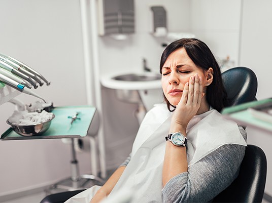 woman wincing in pain
