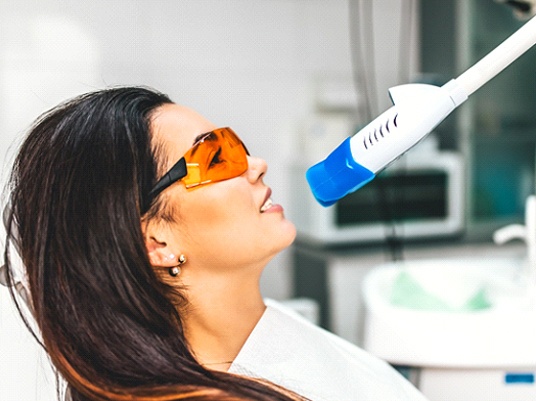 A woman receiving professional teeth whitening.