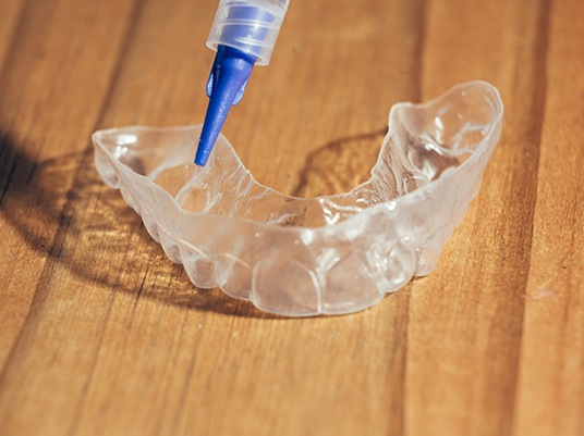 Closeup of teeth whitening tray and gel