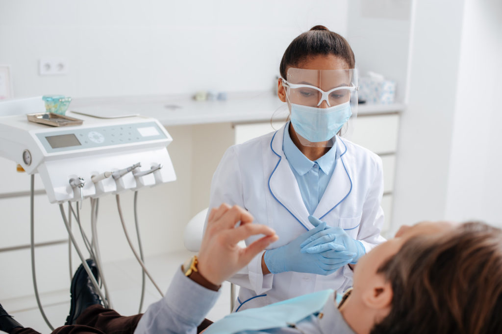 A dentist in Arlington wears a face mask.