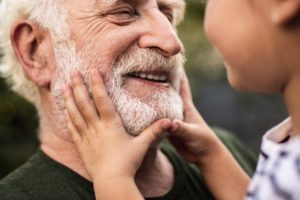 a grandchild looking at their grandparent's smile